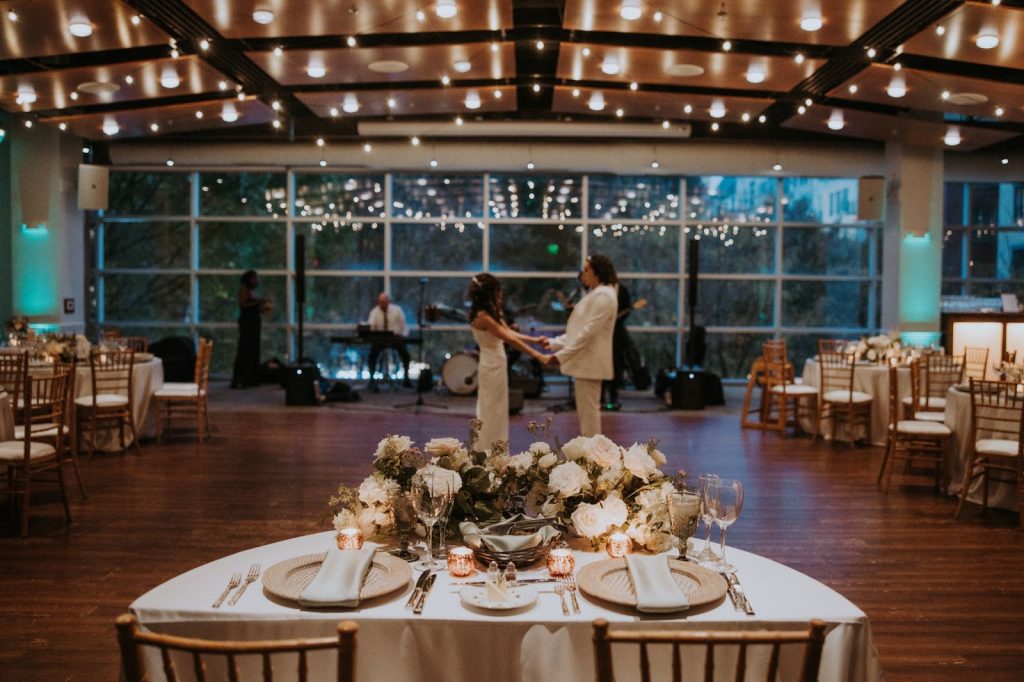Wedding photo of a sweetheart table in front of two brides at VisArts in Rockville, MD