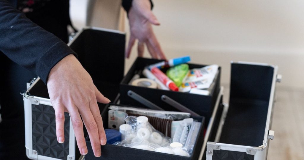 A photo of a wedding planner opening her wedding day emergency kit with contents inside.