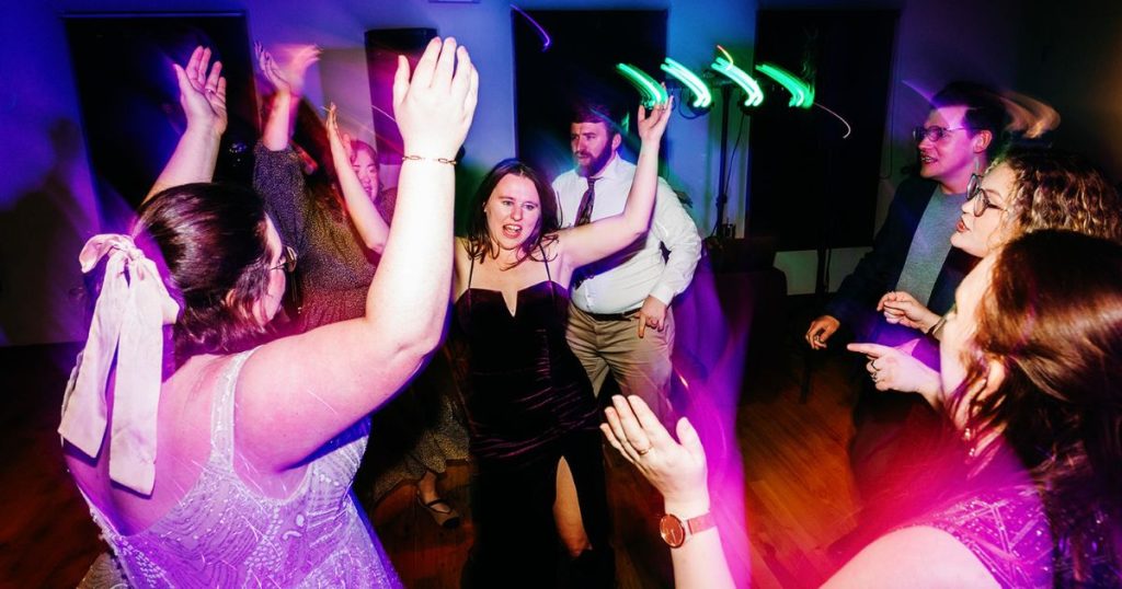 Guests dancing at Pinstripes DC wedding with party lighting