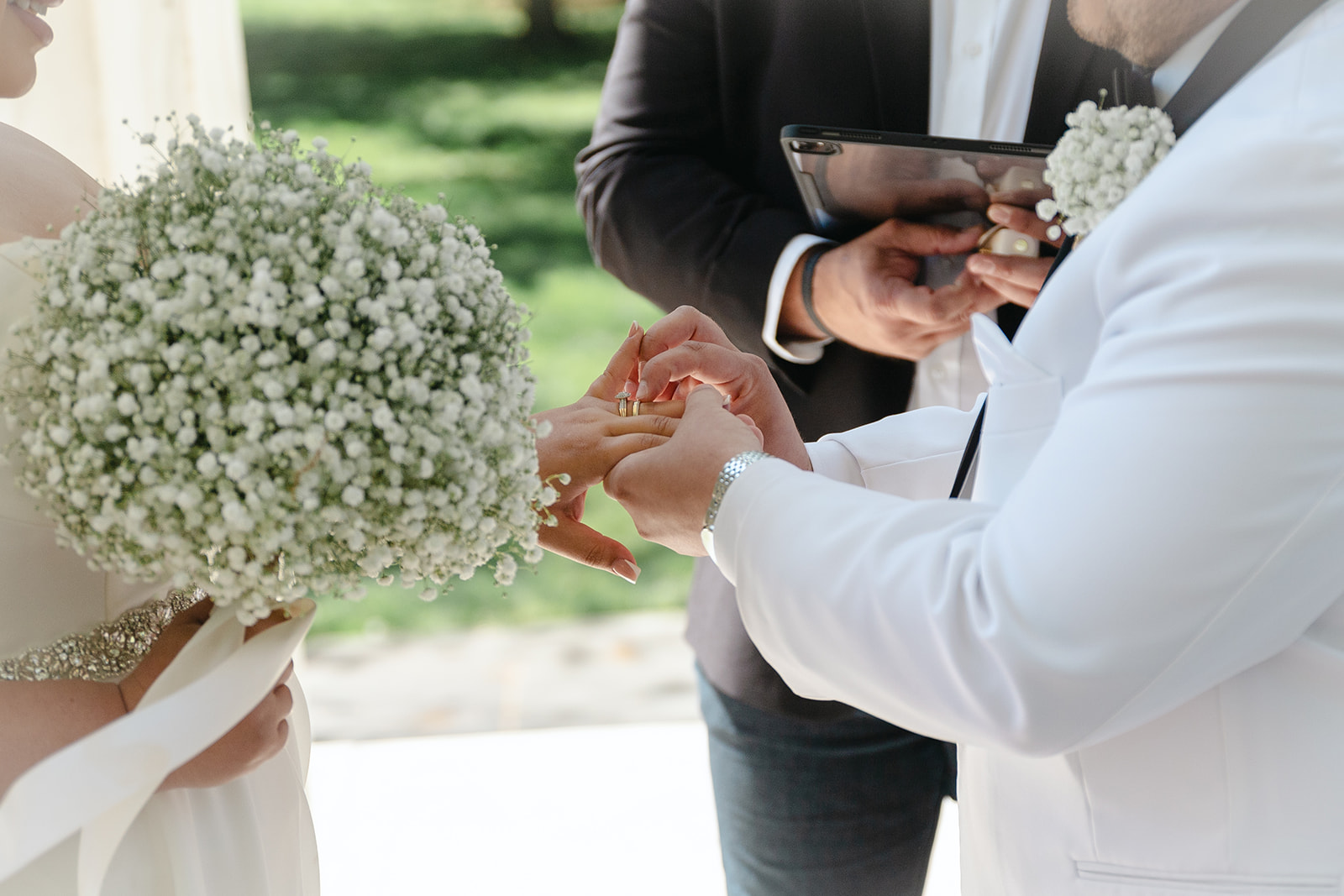 Groom putting the ring on brides hand close up