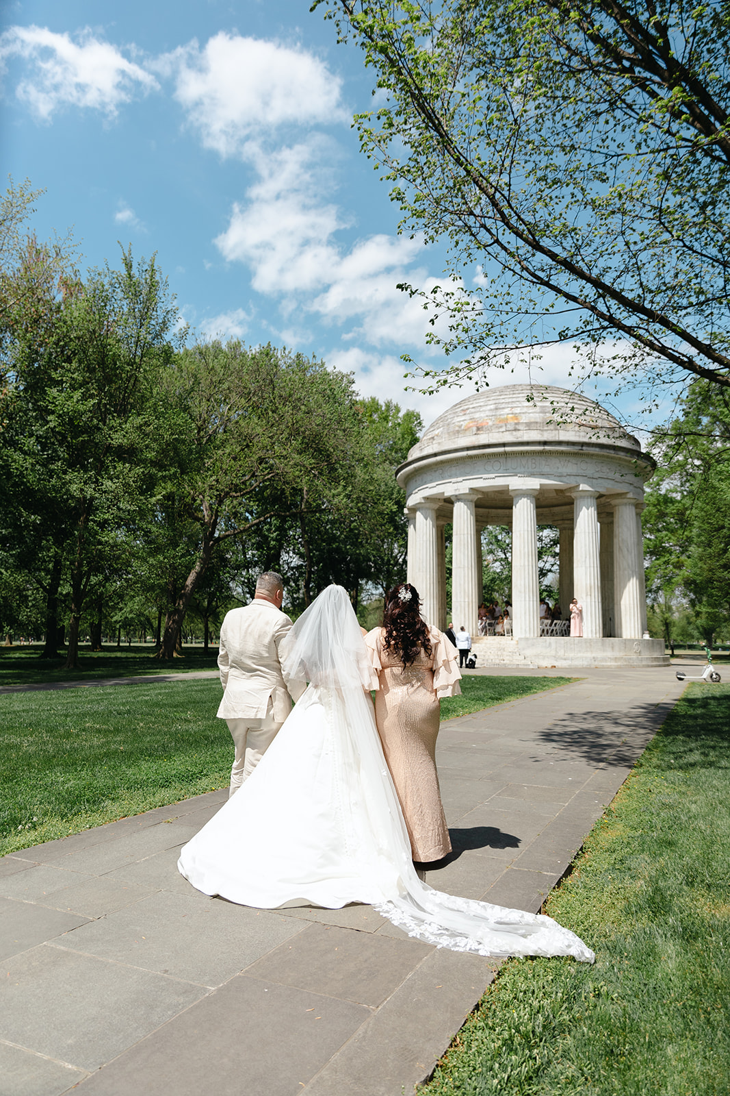Bride with parents walking her over to the DC War Memorial to get married