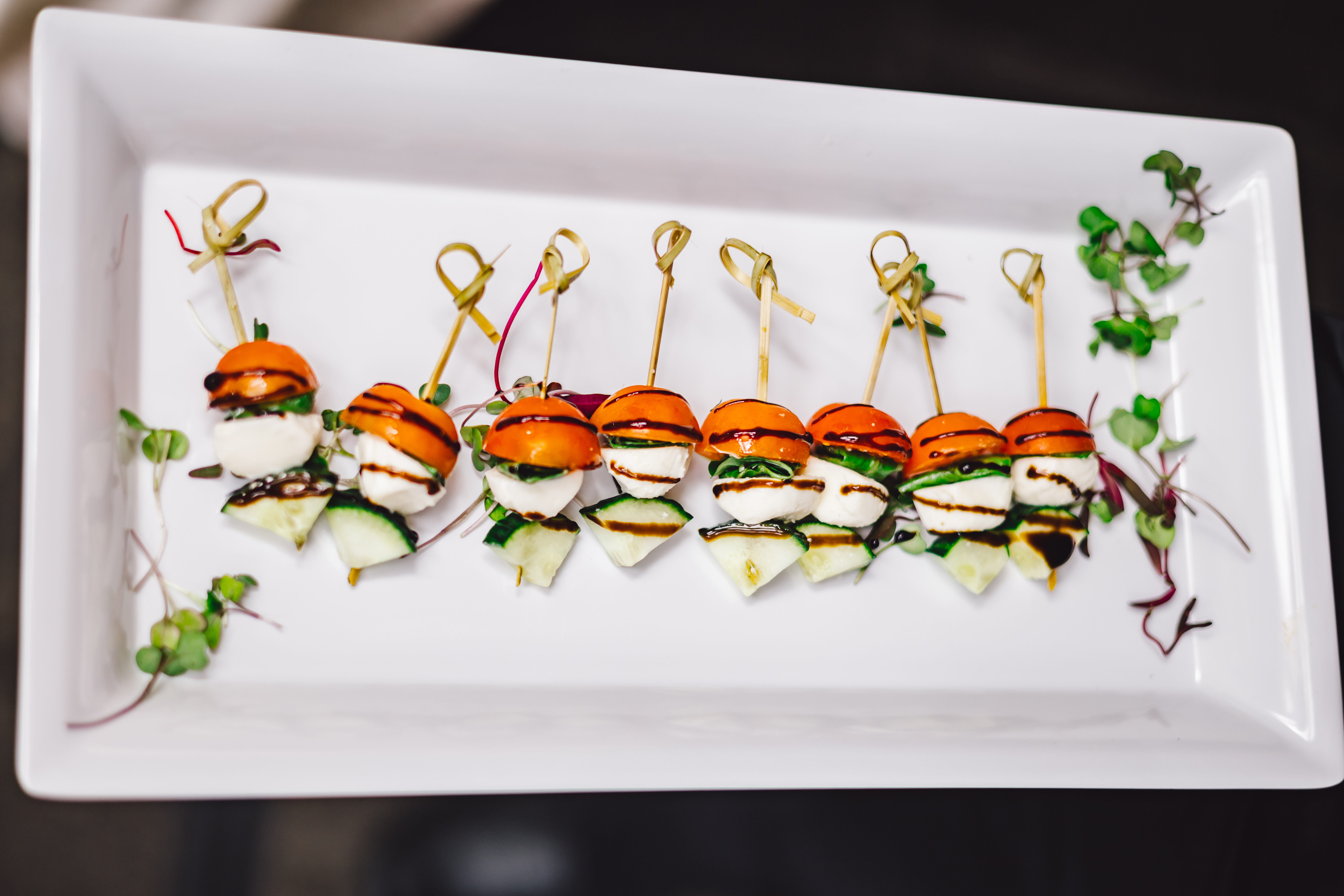 close up of an option for a skewer appetizer of tomato, basil, and mozzarella