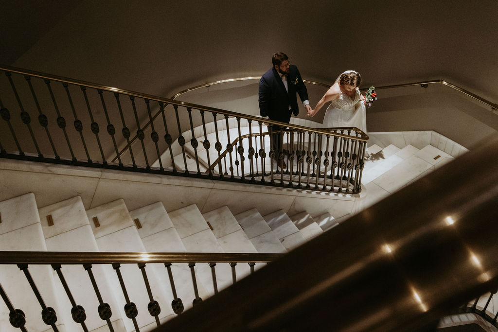 Couple's stairwell portraits at a National Museum of Women in the Arts wedding