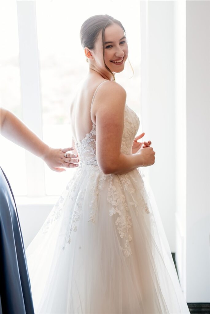 A bride smiling her wedding dress after her Maryland Wedding Dress Appointment.