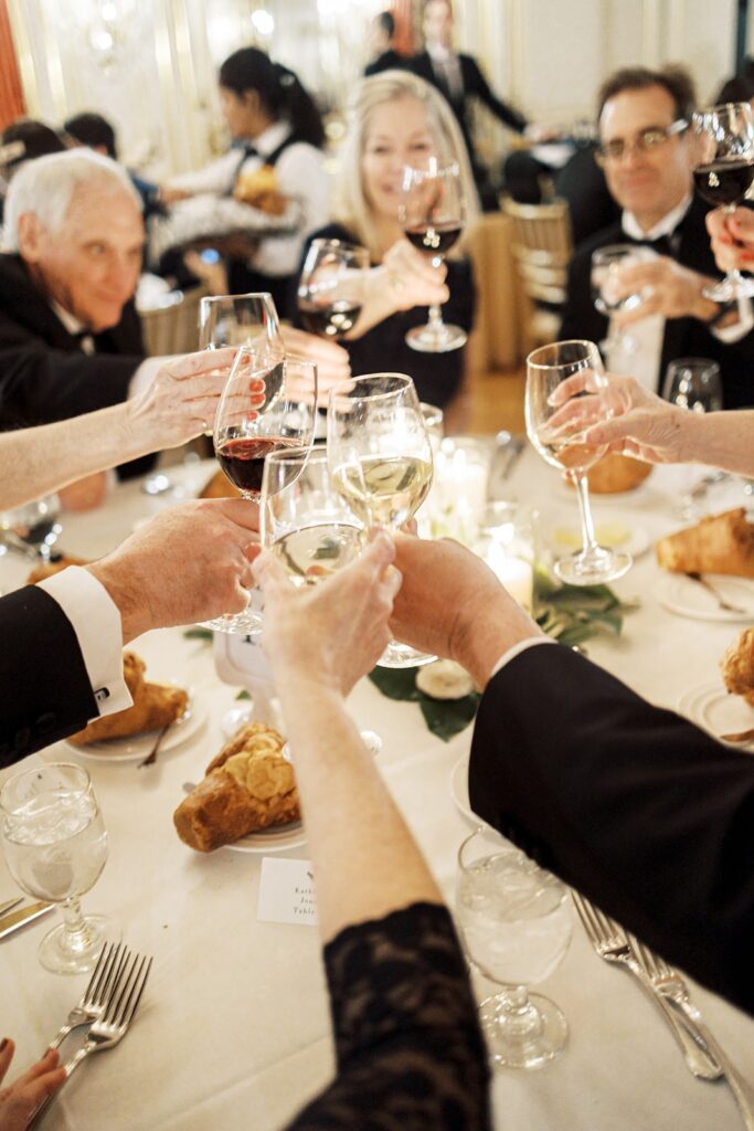 Guests toasting at a wedding reception at Cosmo's Club Hotel