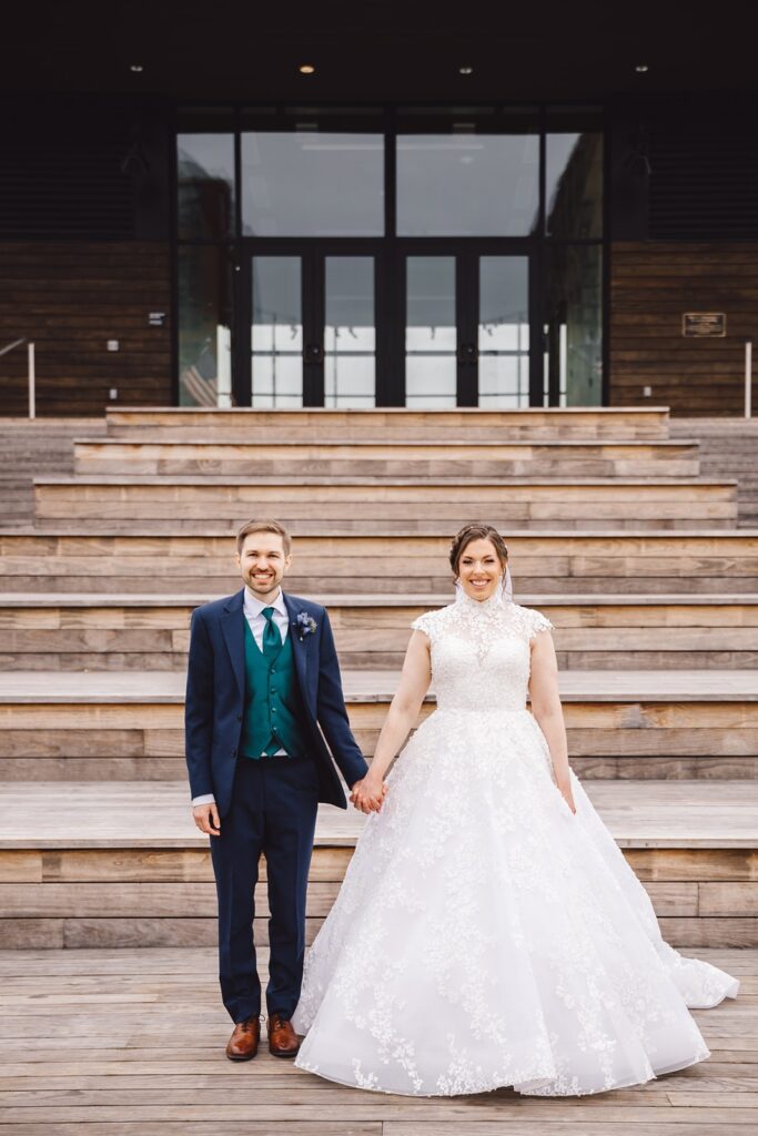 A couple stands in front of the Intercontinental DC Wharf Hotel for wedding portraits.