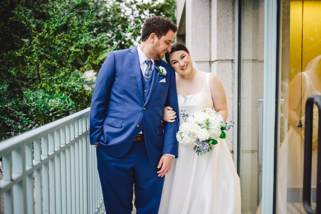 A wedding couple poses together on the balcony of Park Hyatt Hotel in DC.