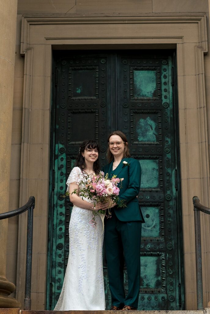 Wedding couple standing in front of a green door for portraits at The Line DC Hotel.