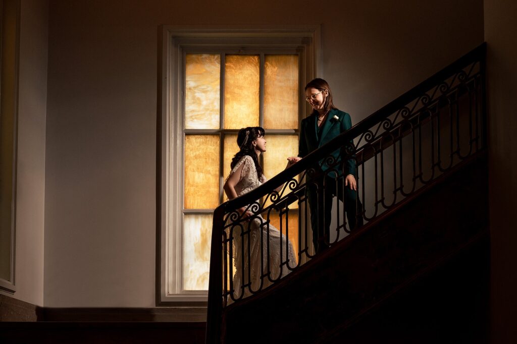 A wedding couple looks at each other on a staircase at The Line DC Hotel.