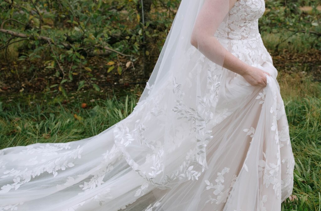 Up close dress details of a spouse-to-be at her Showalter's Orchard and Greenhouse Wedding