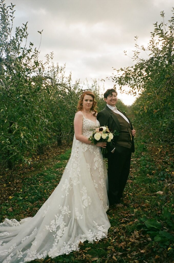 A couple poses for portraits for their Showalter's Orchard and Greenhouse Wedding