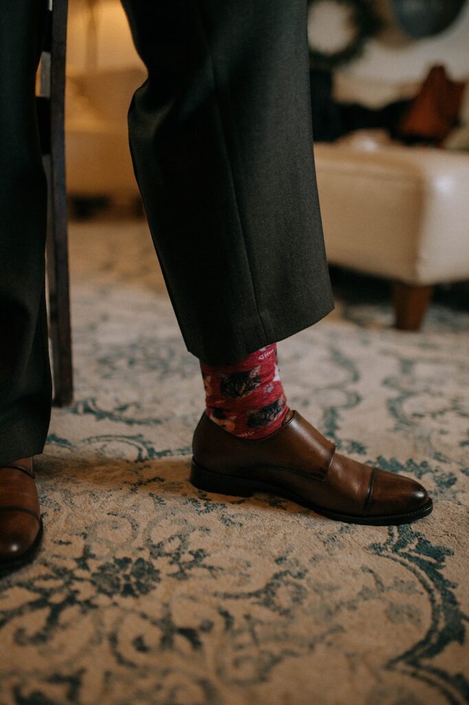 A spouse-to-be showing off their cat socks in the Showalter's Orchard and Greenhouse farmhouse