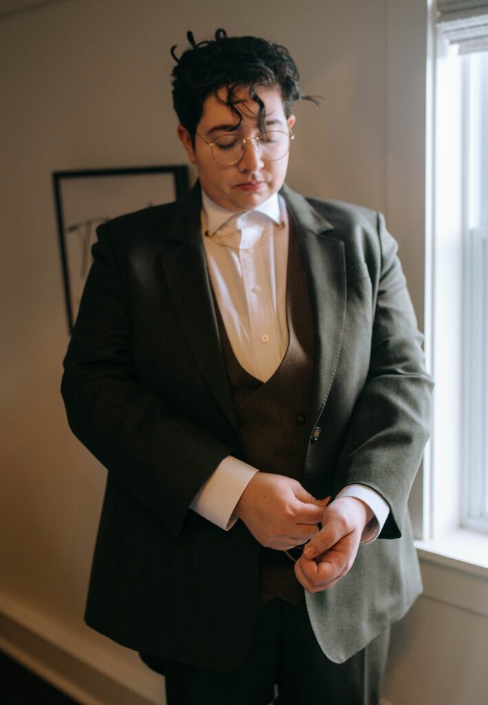 A spouse-to-be getting ready for their ceremony in the Showalter's Orchard and Greenhouse farmhouse