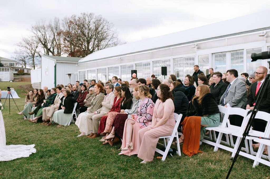 Guests sitting at the ceremony at a Showalter's Orchard and Greenhouse Wedding