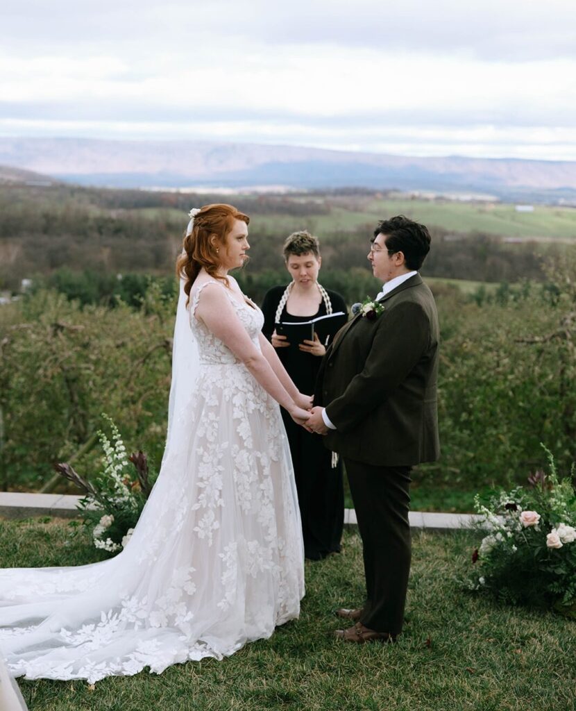 A couple at the ceremony of their Showalter's Orchard and Greenhouse Wedding overlooking the Shenandoah Valley
