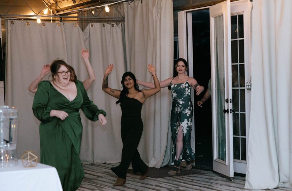 Wedding party comes dancing into the reception