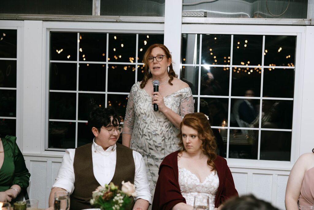 Loved ones sharing toasts at a couples wedding reception