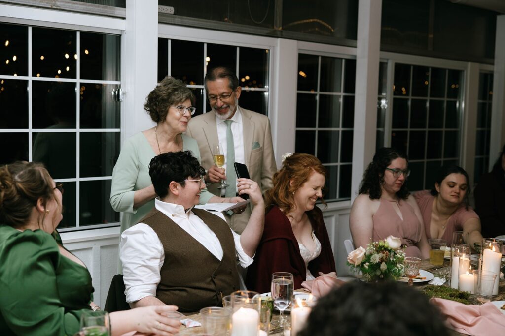 Loved ones sharing toasts at a couples wedding reception